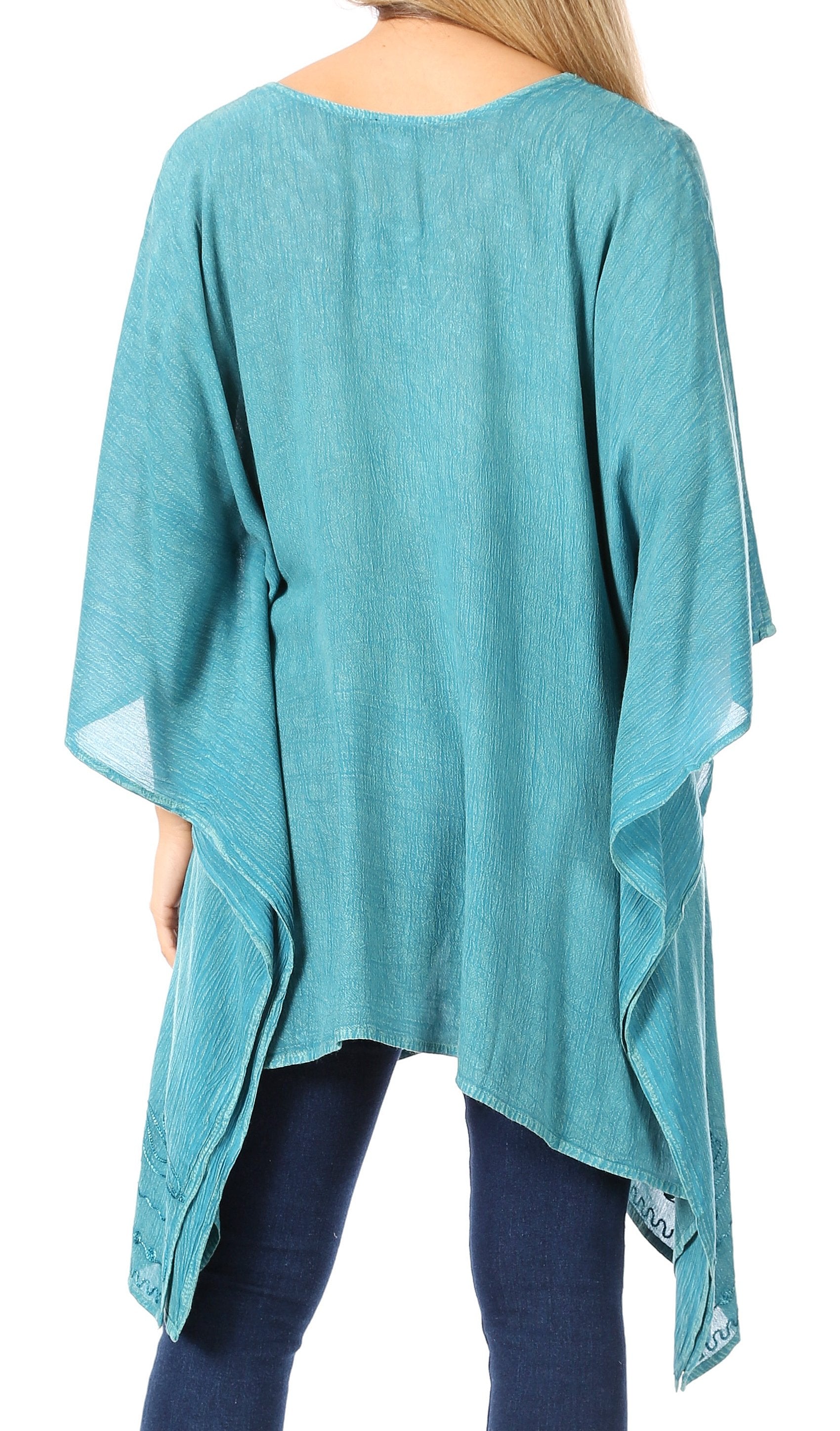 Teal poncho worn by a person on a white background