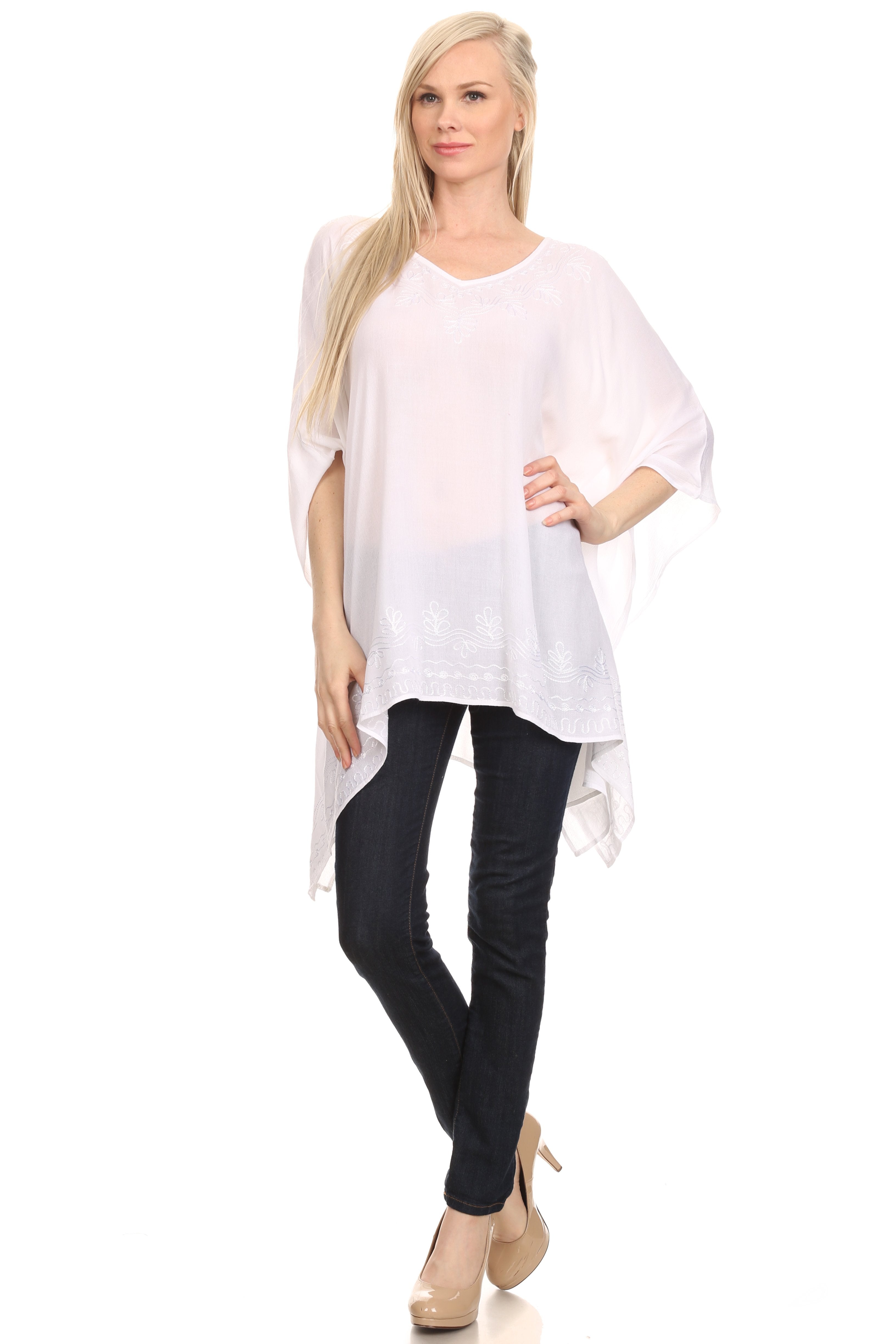 Woman wearing a white oversized top and black pants on a white background