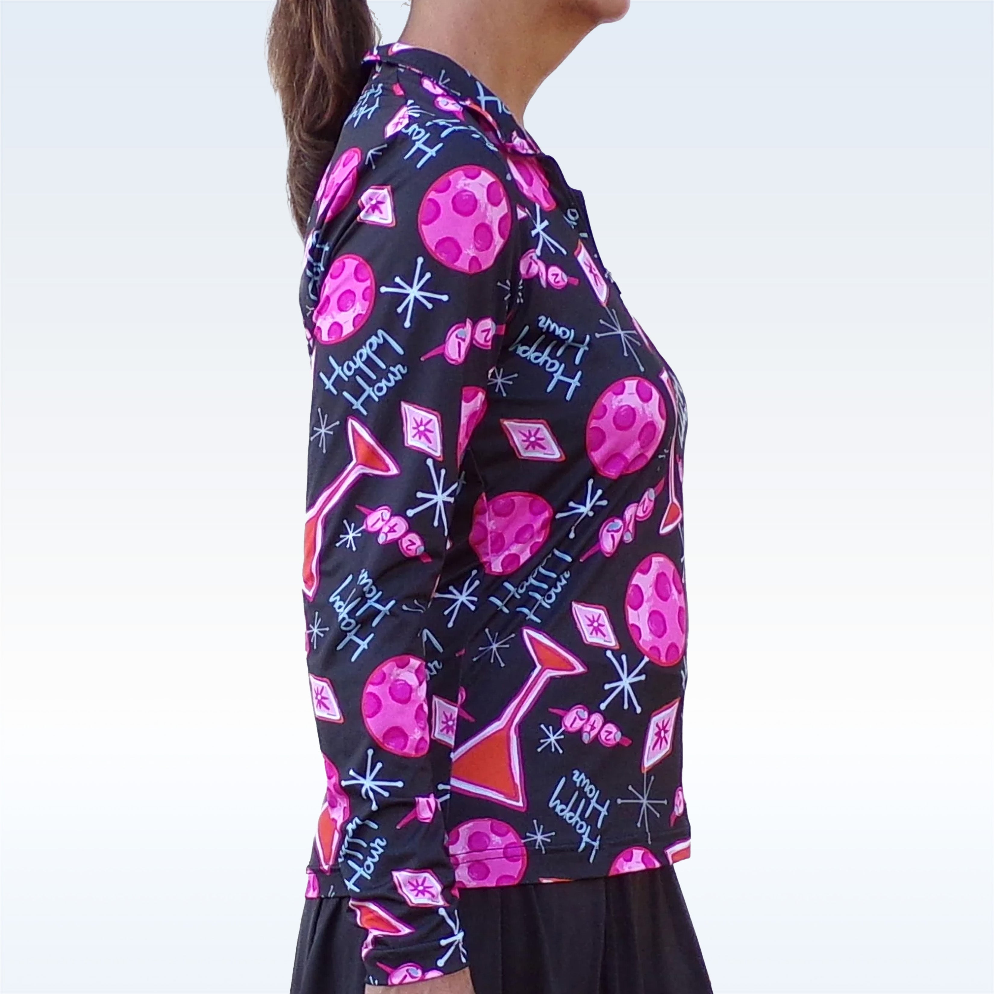 Person wearing a colorful patterned shirt with pink geometric shapes and text on a black background.