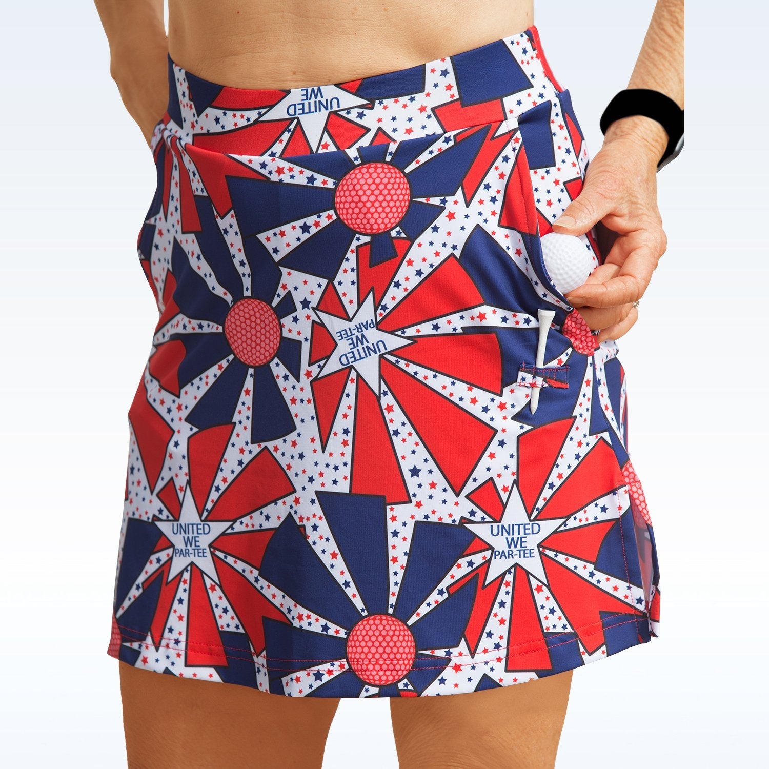 Person wearing a red, white, and blue patterned skirt with a sports ball.