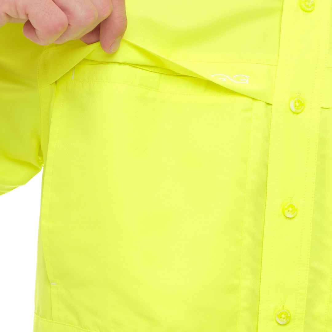 Close-up of a bright yellow shirt with buttons on a white background