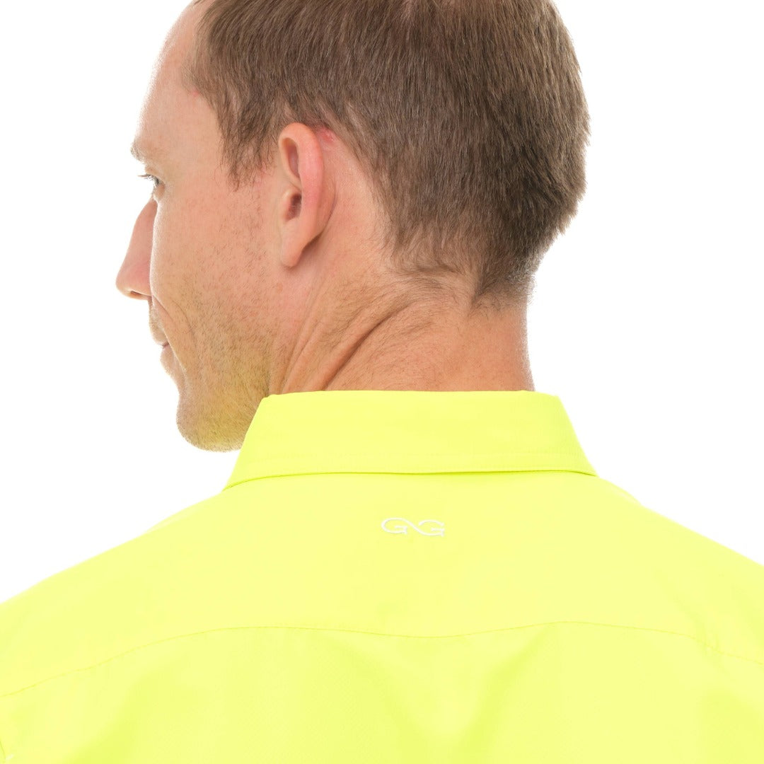 Man wearing a bright yellow shirt with a visible brand logo on a white background