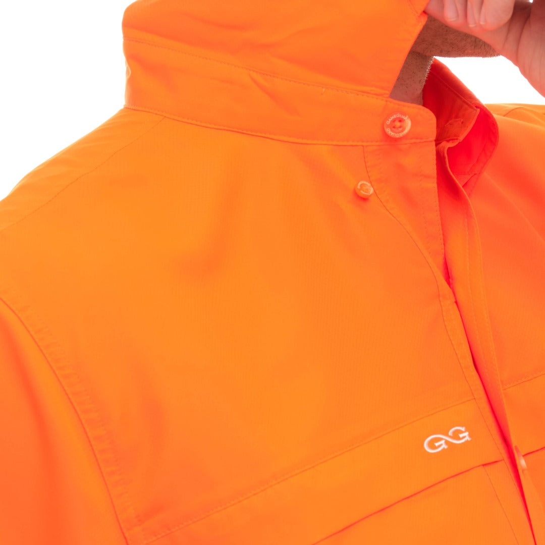 Close-up of an orange jacket with a brand logo on a white background