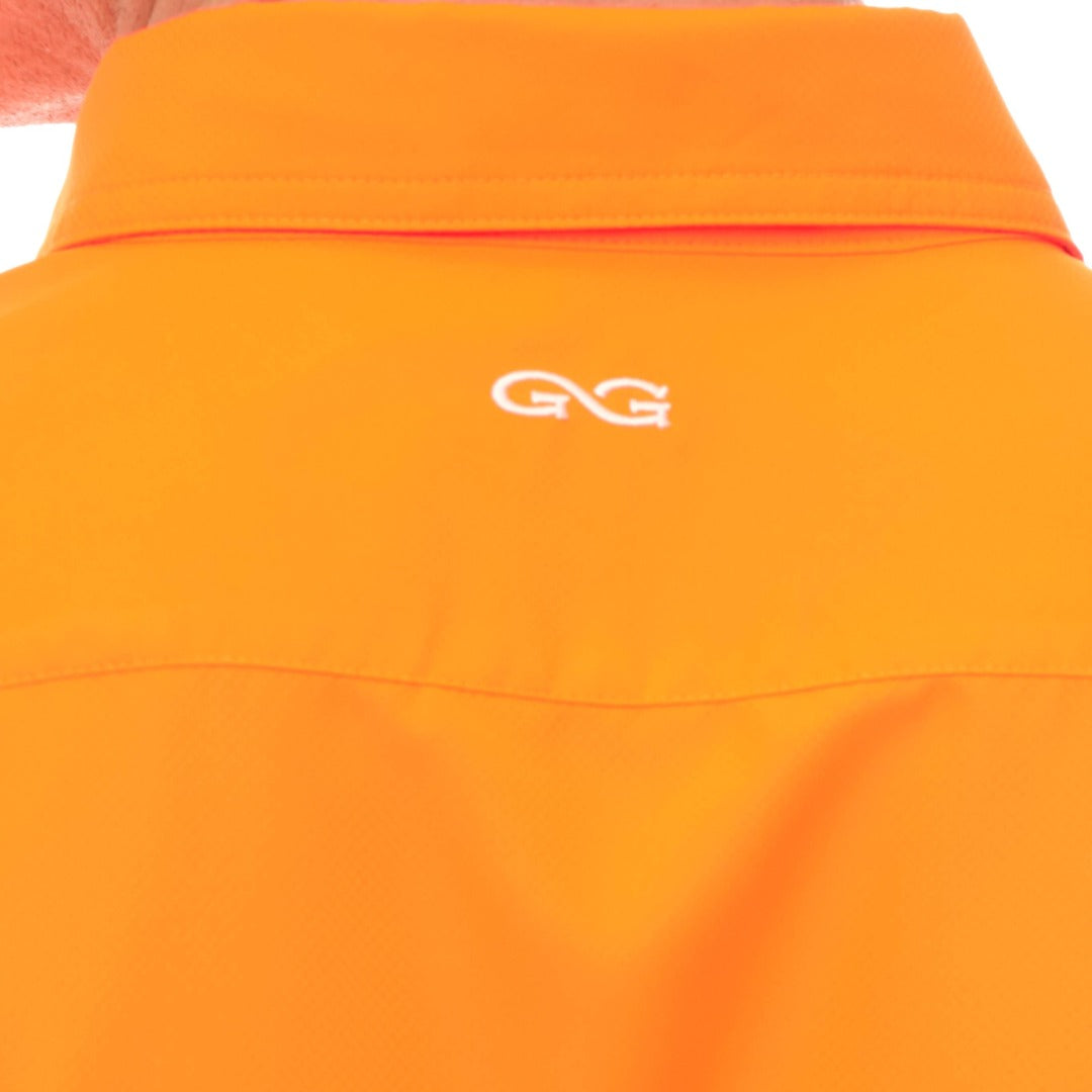 Close-up of an orange jacket with a logo on a white background