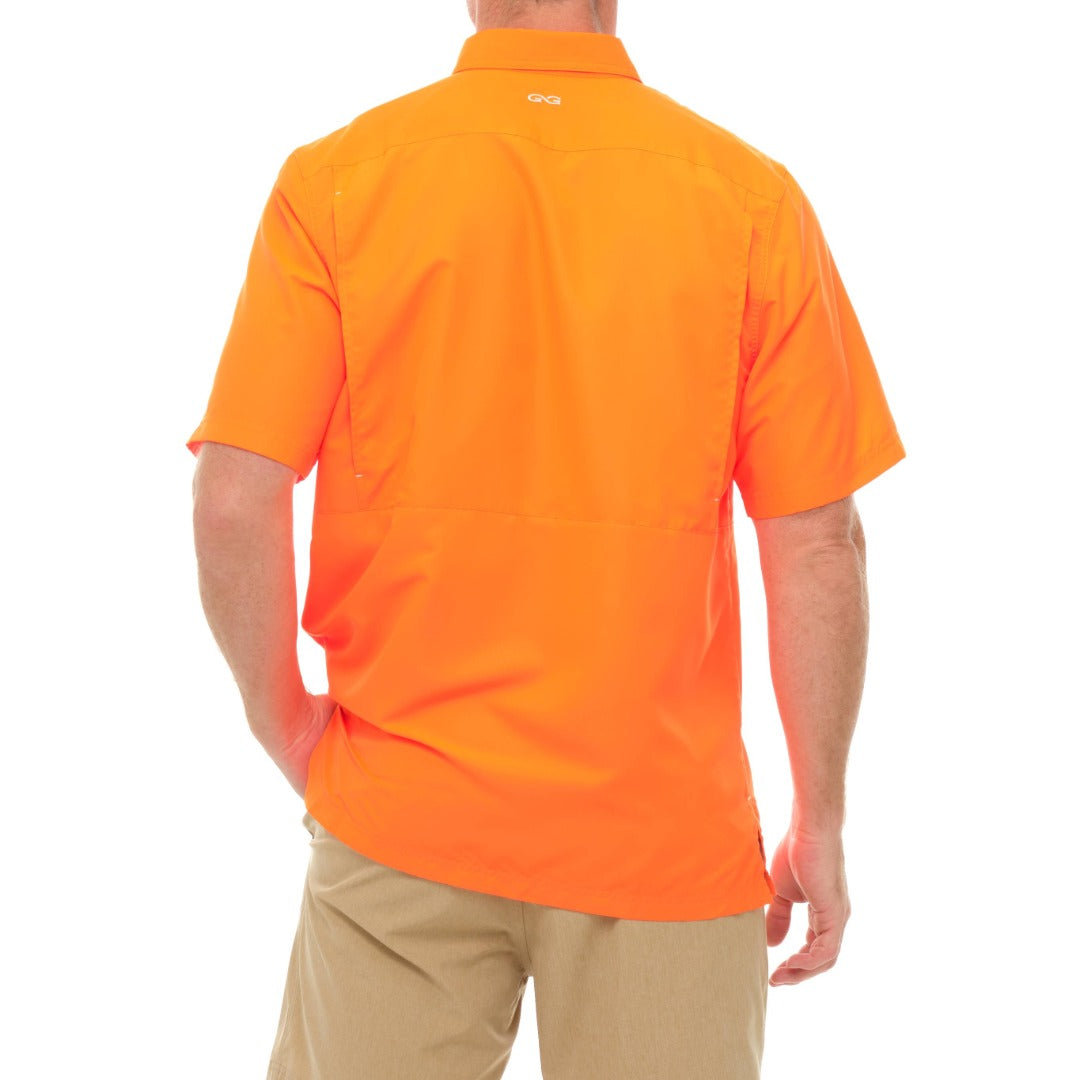 Orange polo shirt worn by a person on a white background