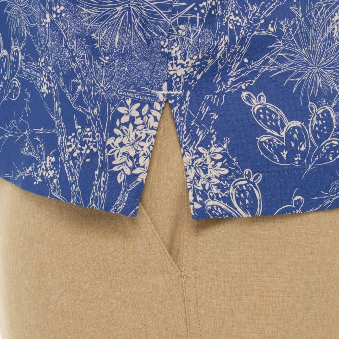 Close-up of a blue floral patterned shirt collar with beige fabric underneath