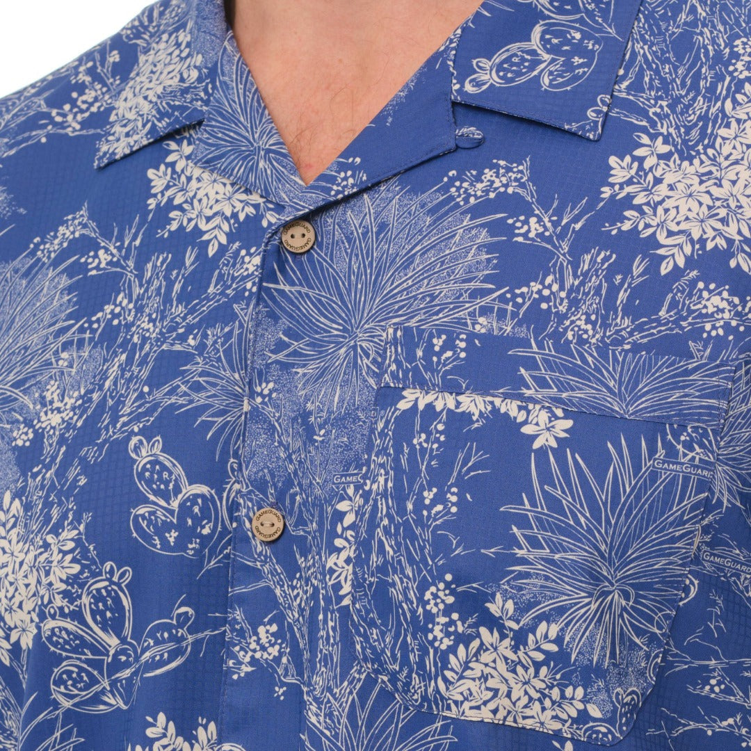 Blue shirt with white floral and plant pattern