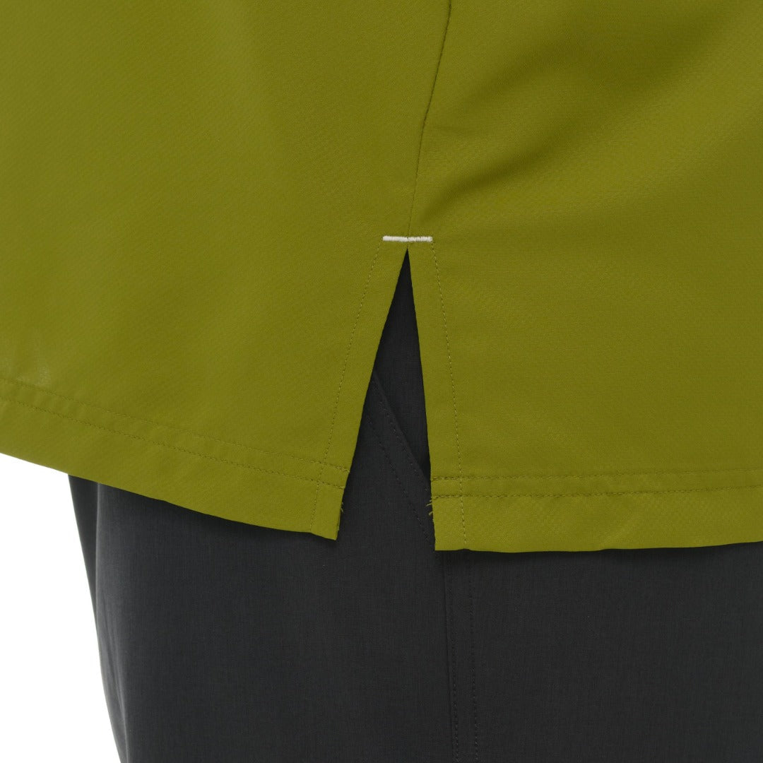 Close-up of green shorts with a visible brand logo on a white background