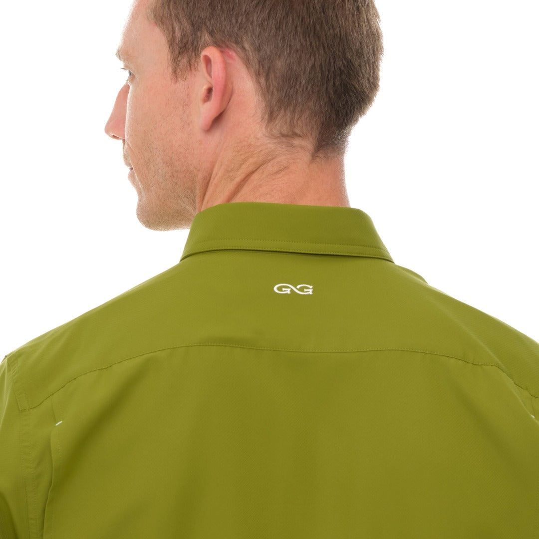 Green shirt with a logo on the collar against a white background