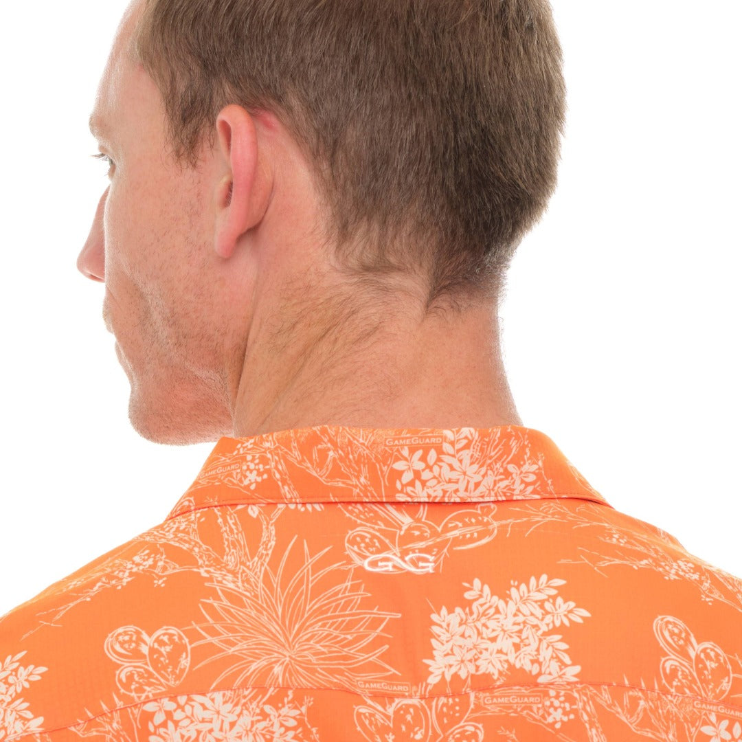 Man wearing an orange floral shirt on a white background