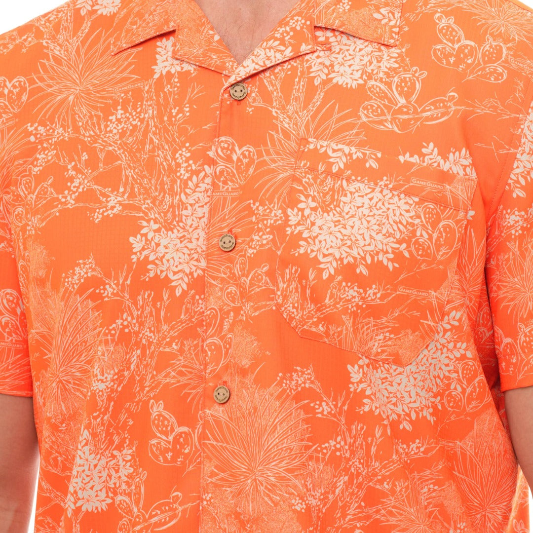 Orange shirt with white floral pattern worn by a person