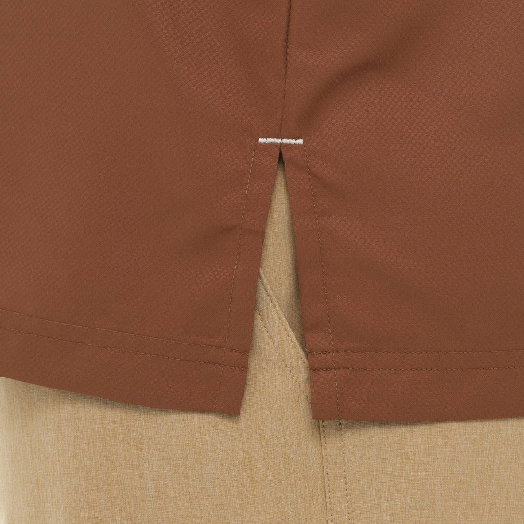 Close-up of brown shorts with a visible brand label.