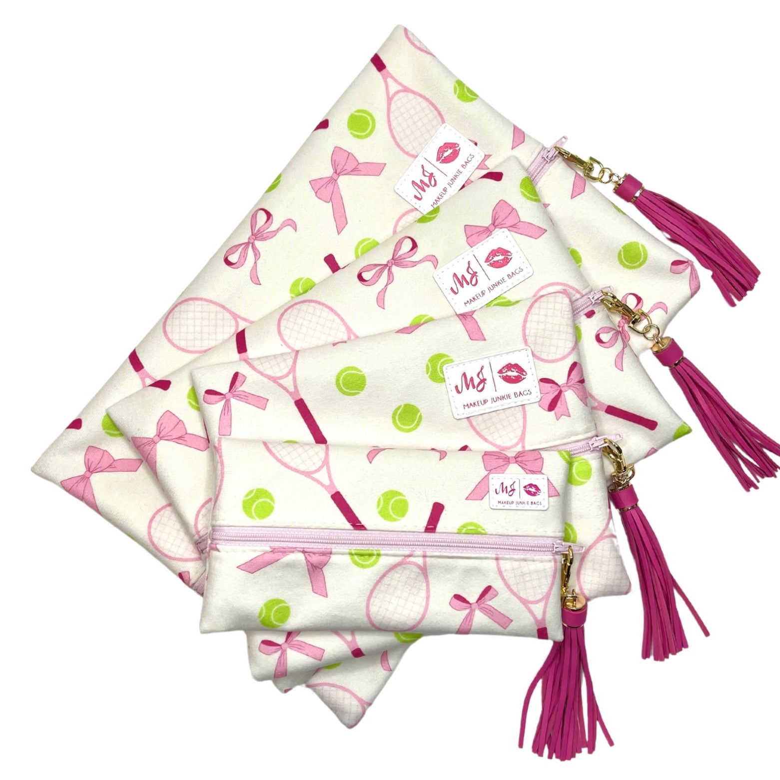 Set of makeup bags with pink tassels and decorative patterns on a white background
