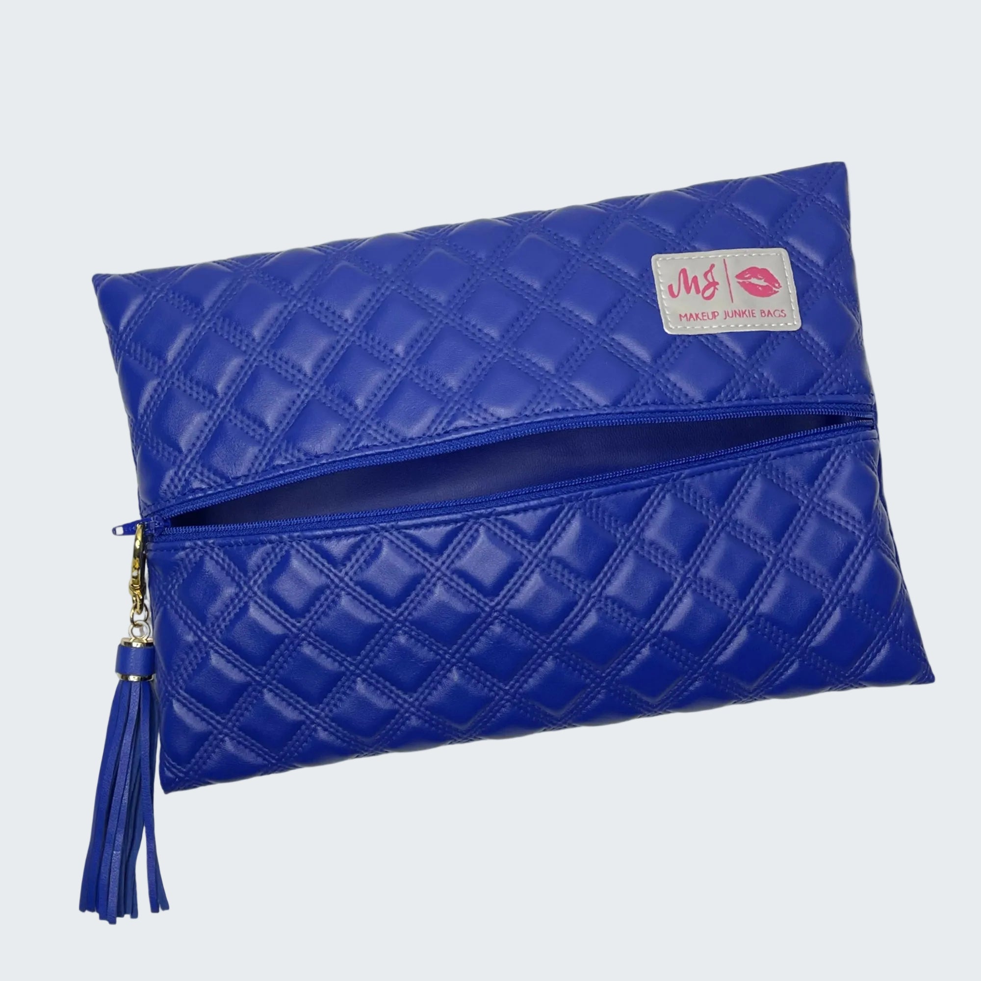 Blue quilted clutch bag with a brand label on a white background
