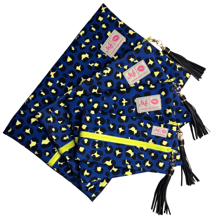Blue bags with yellow patterns and black tassels on a white background