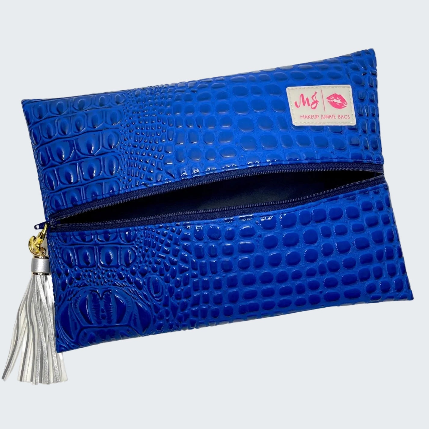 Blue textured clutch bag with a tassel on a white background
