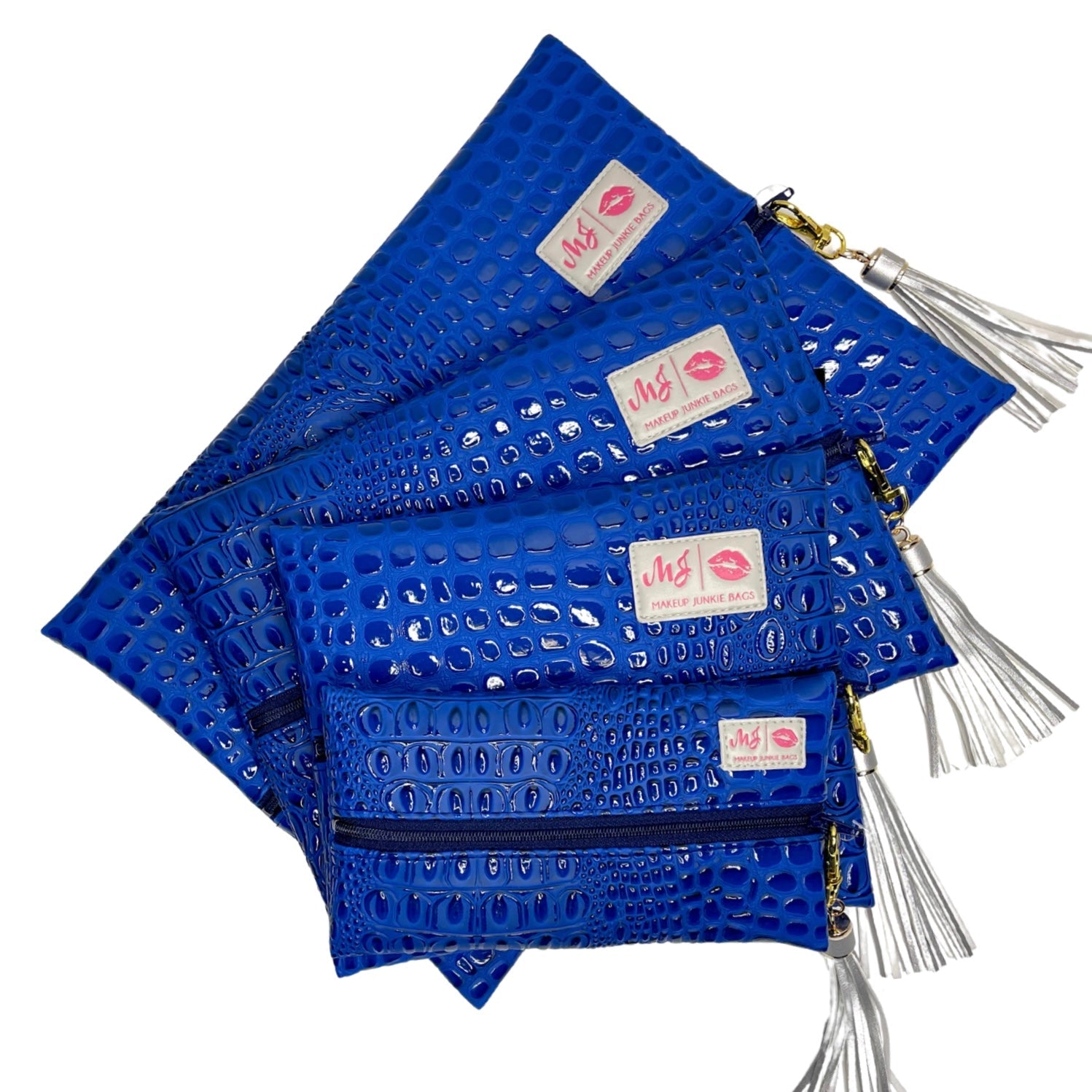 Set of blue patterned pouches with tassels on a white background