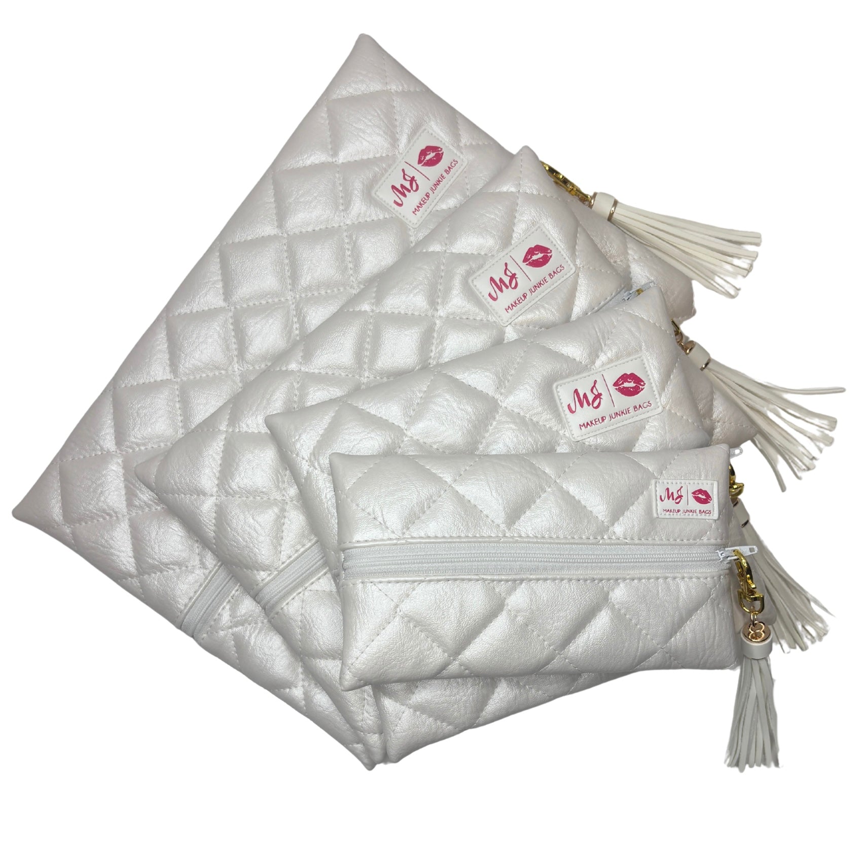 Set of white quilted pouches with tassels on a white background