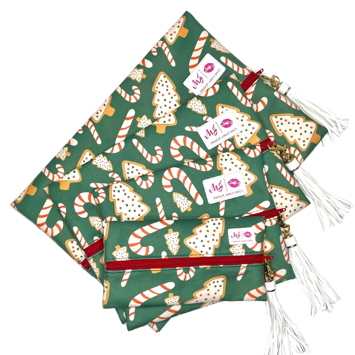 Green fabric bags with Christmas-themed patterns and visible branding on a white background