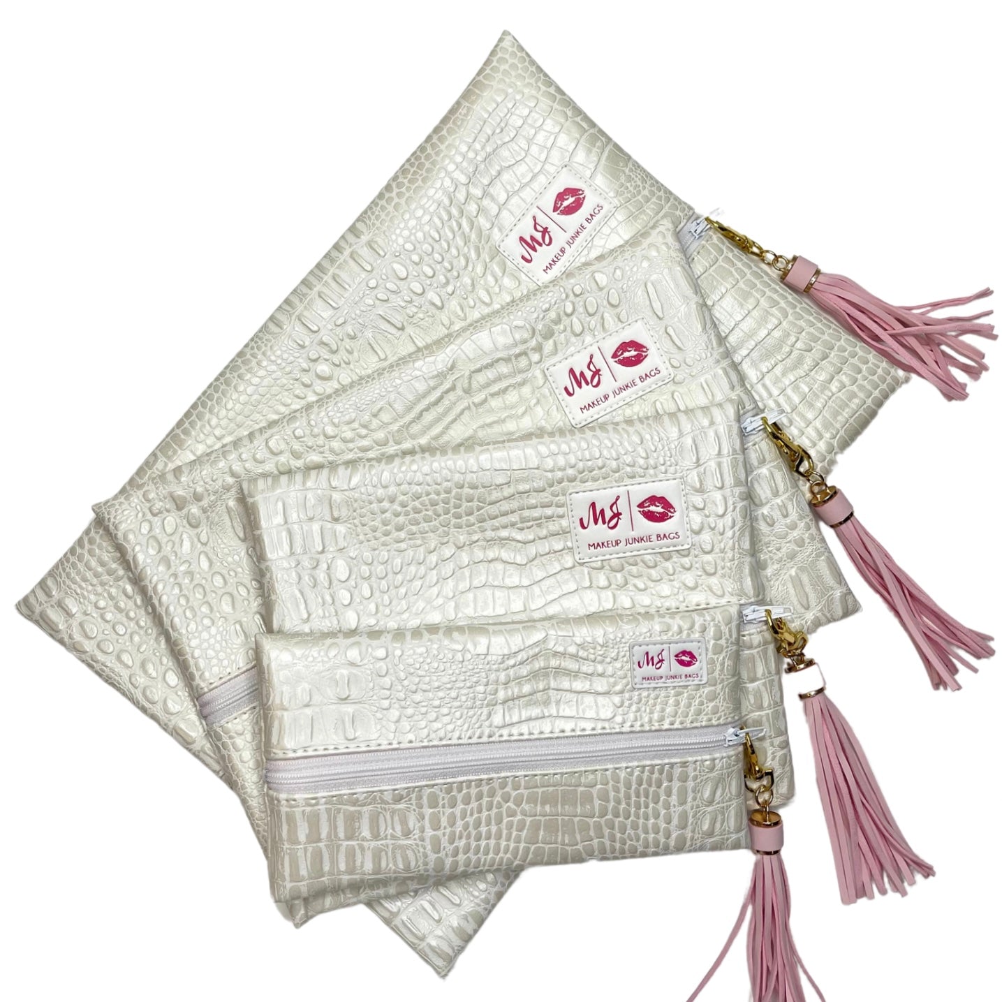 Set of white makeup bags with pink tassels and visible brand logo on a white background