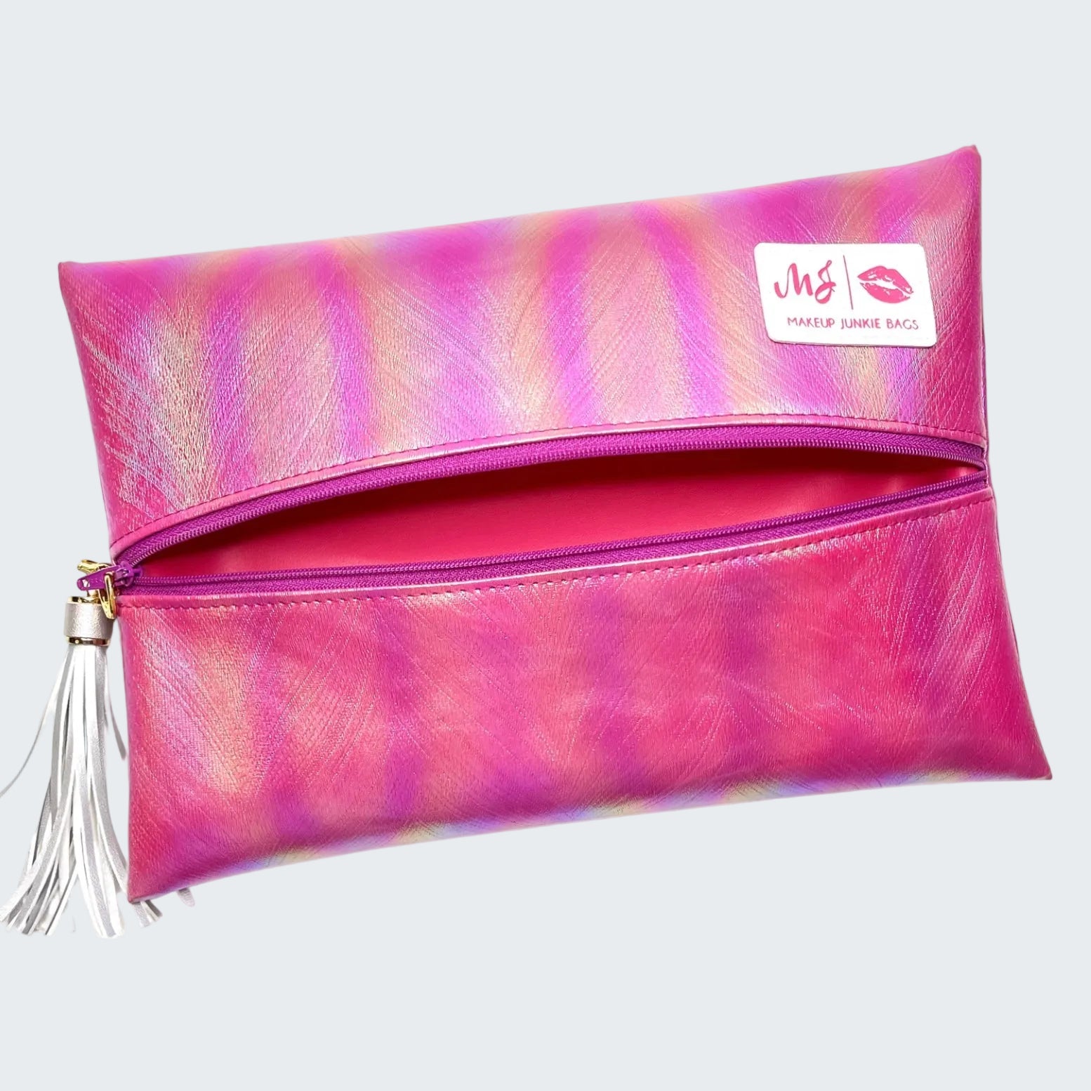 Pink and purple makeup bag with a tassel on a white background