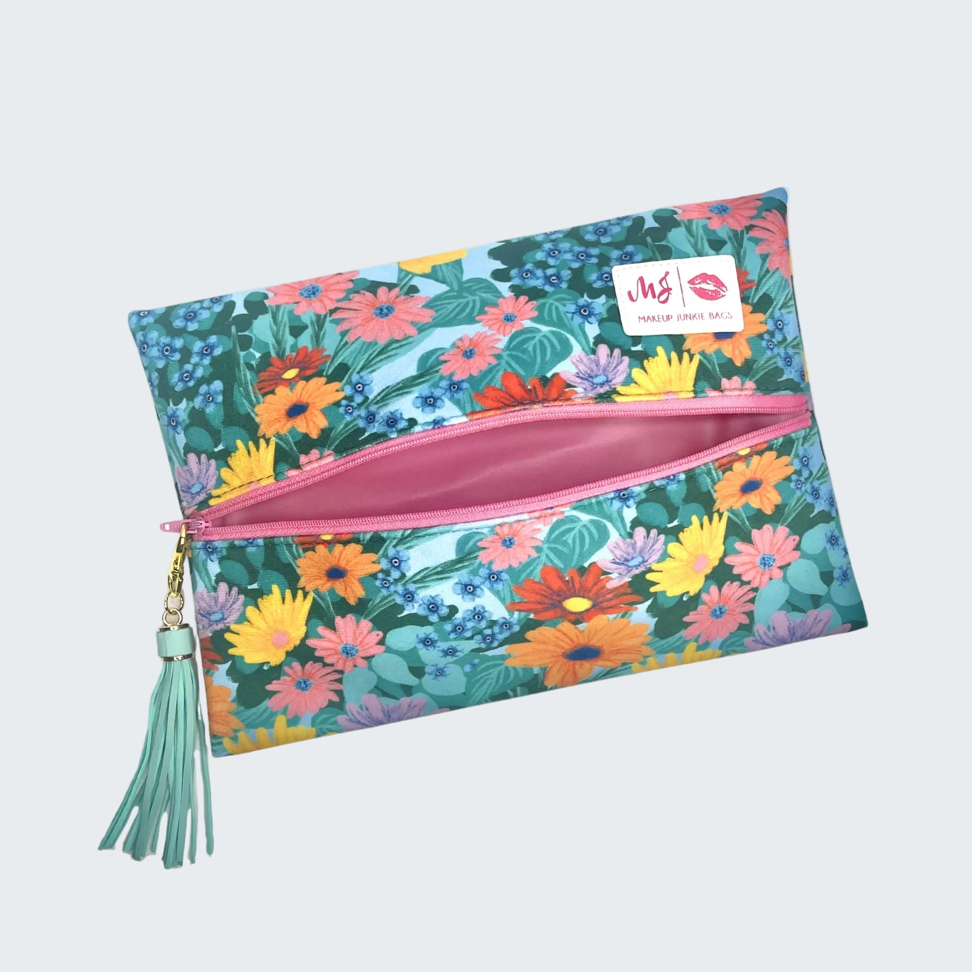 Floral-patterned pouch with a pink zipper and tassel on a white background