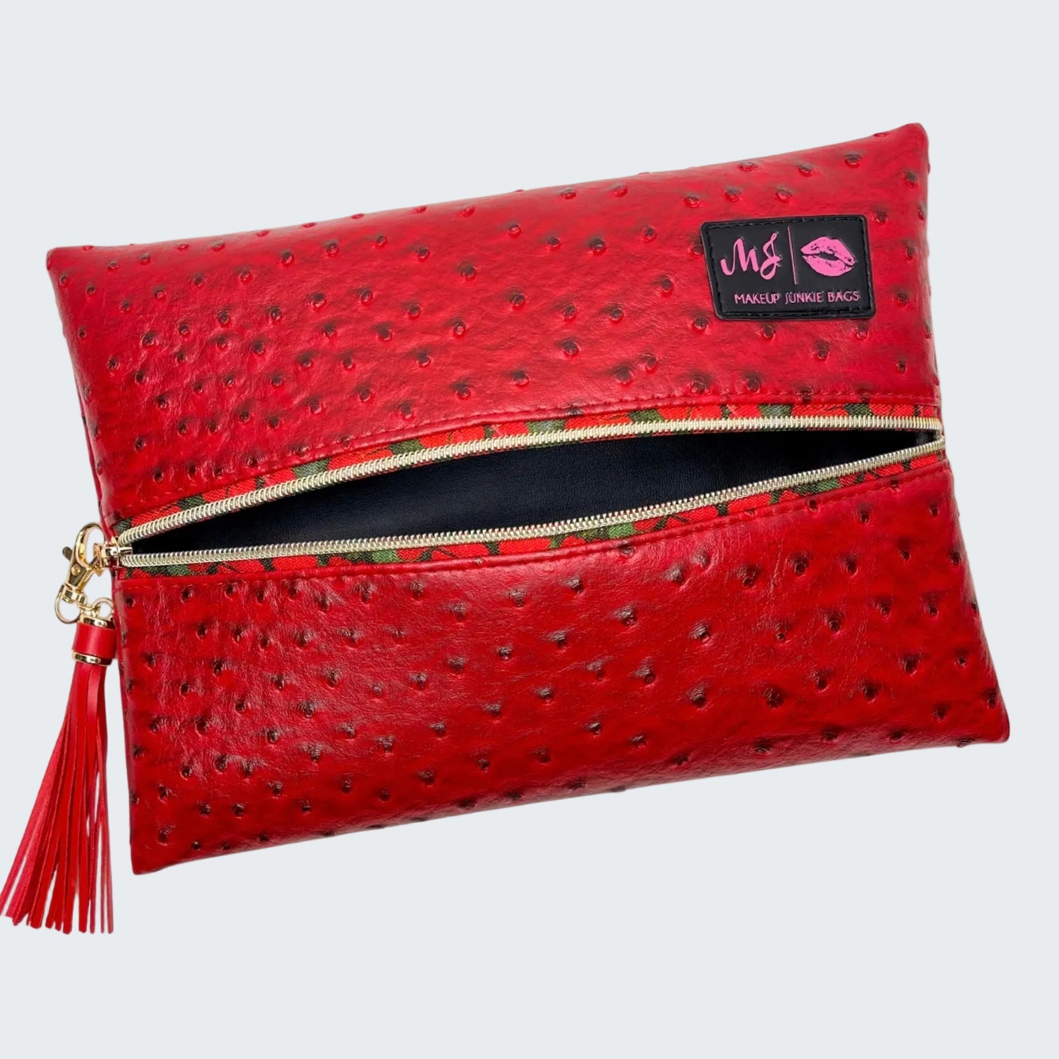 Red clutch bag with a visible brand label on a white background