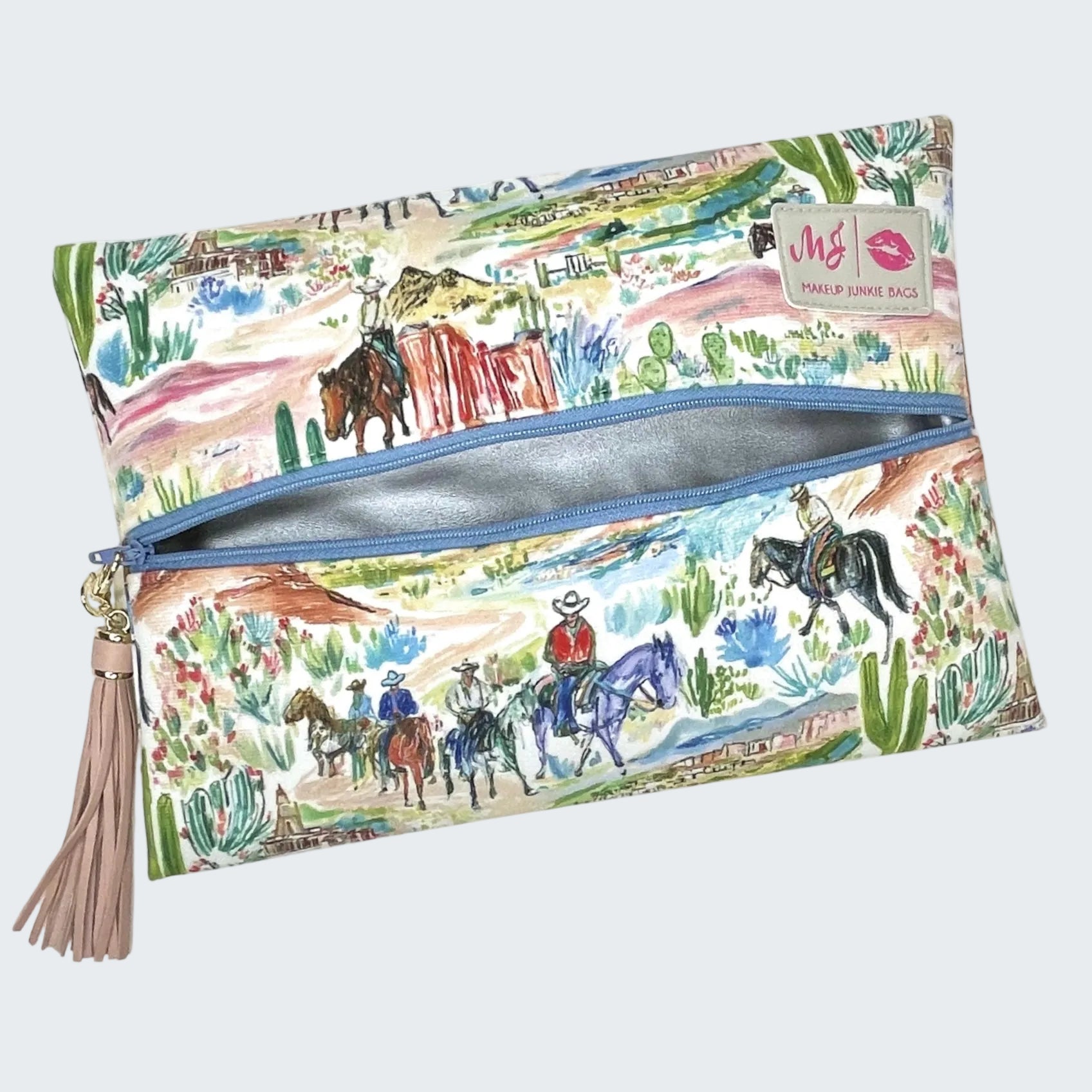 Makeup bag with desert scene design featuring horses and cacti, with a visible brand label.