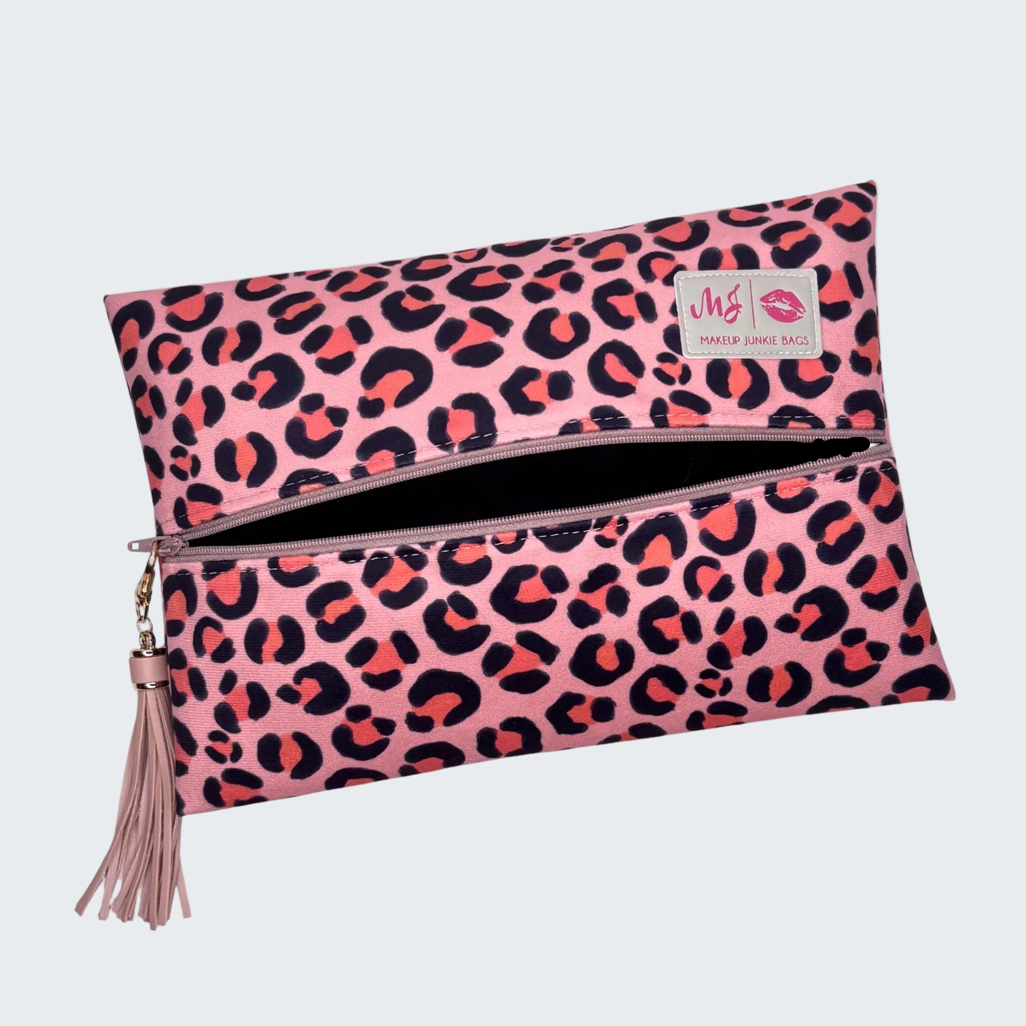 Pink leopard print pouch with a tassel on a white background
