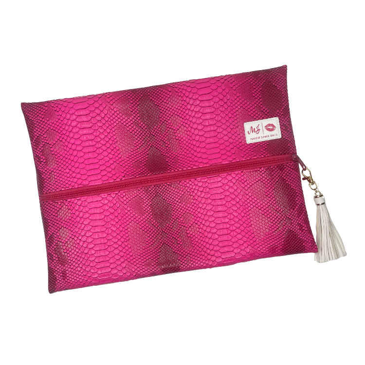 Pink textured pouch with a tassel on a white background