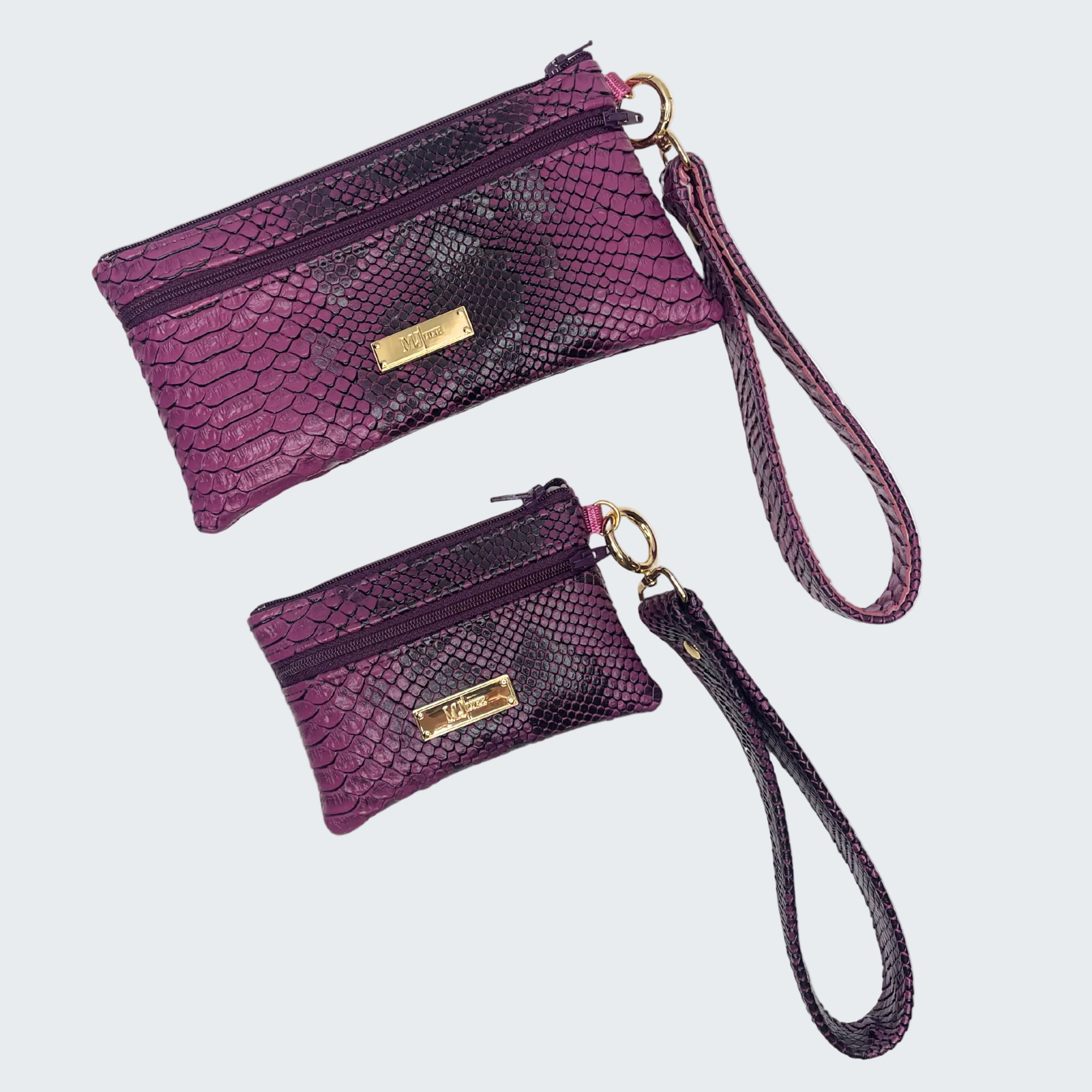 Two purple wristlets with gold accents on a white background