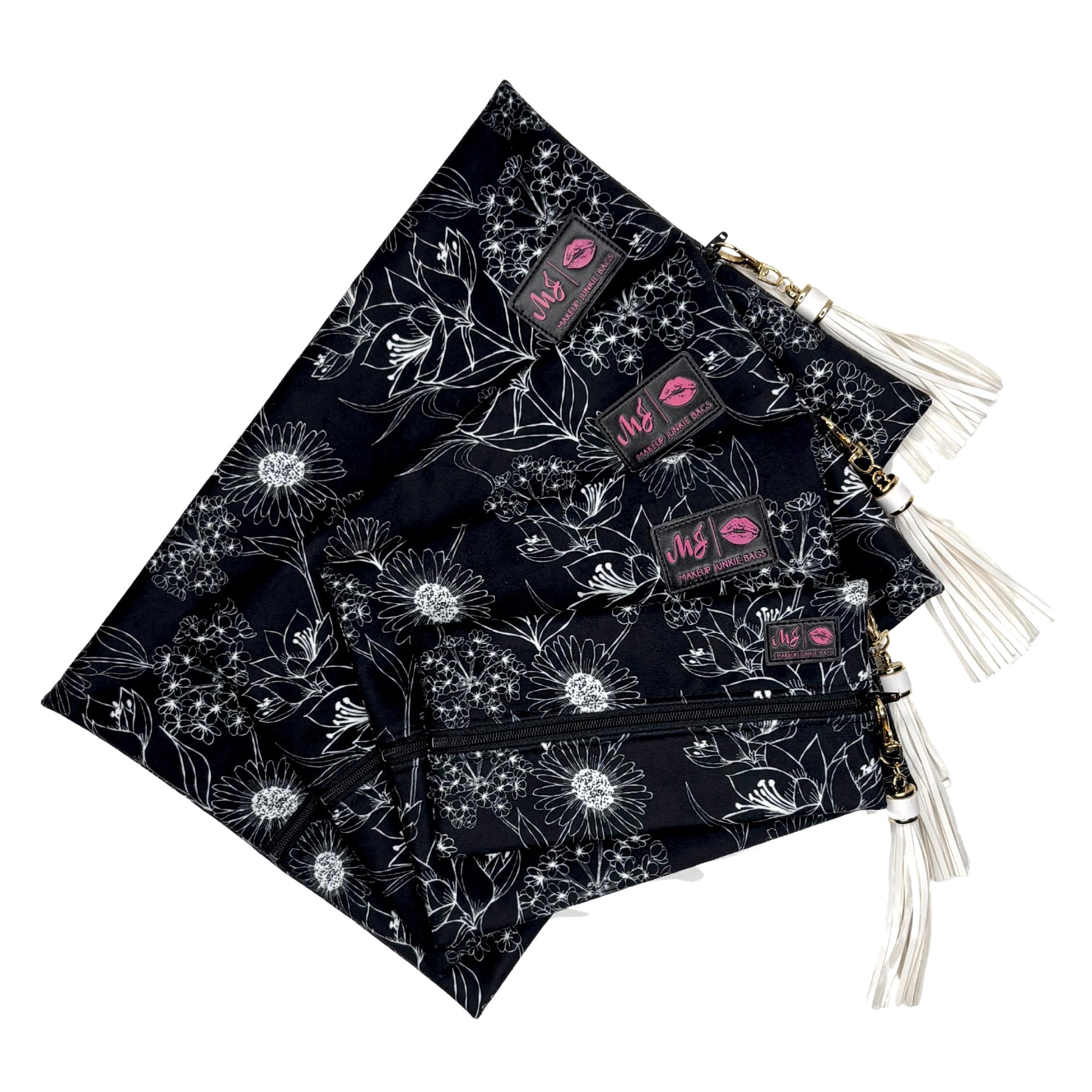 Black bags with white floral patterns and visible brand labels on a white background