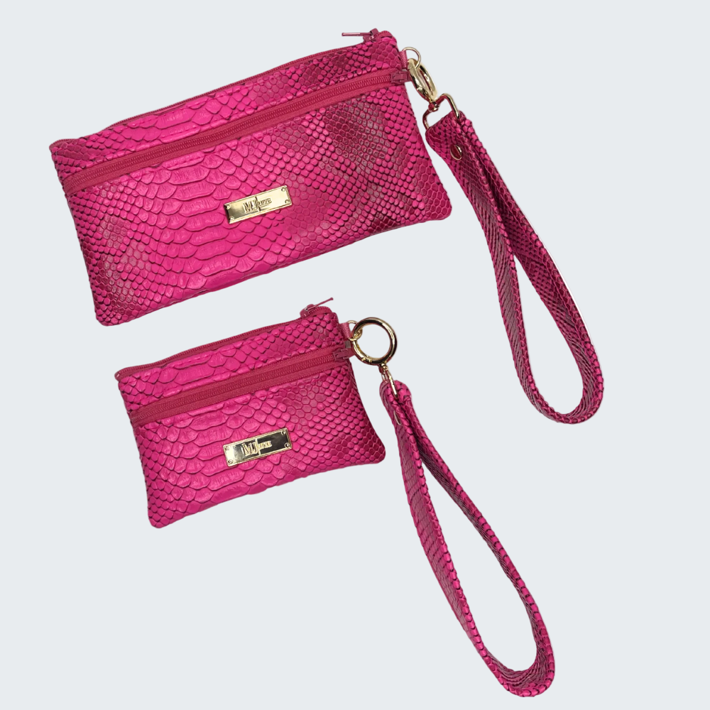 Two pink textured handbags with wristlets on a white background
