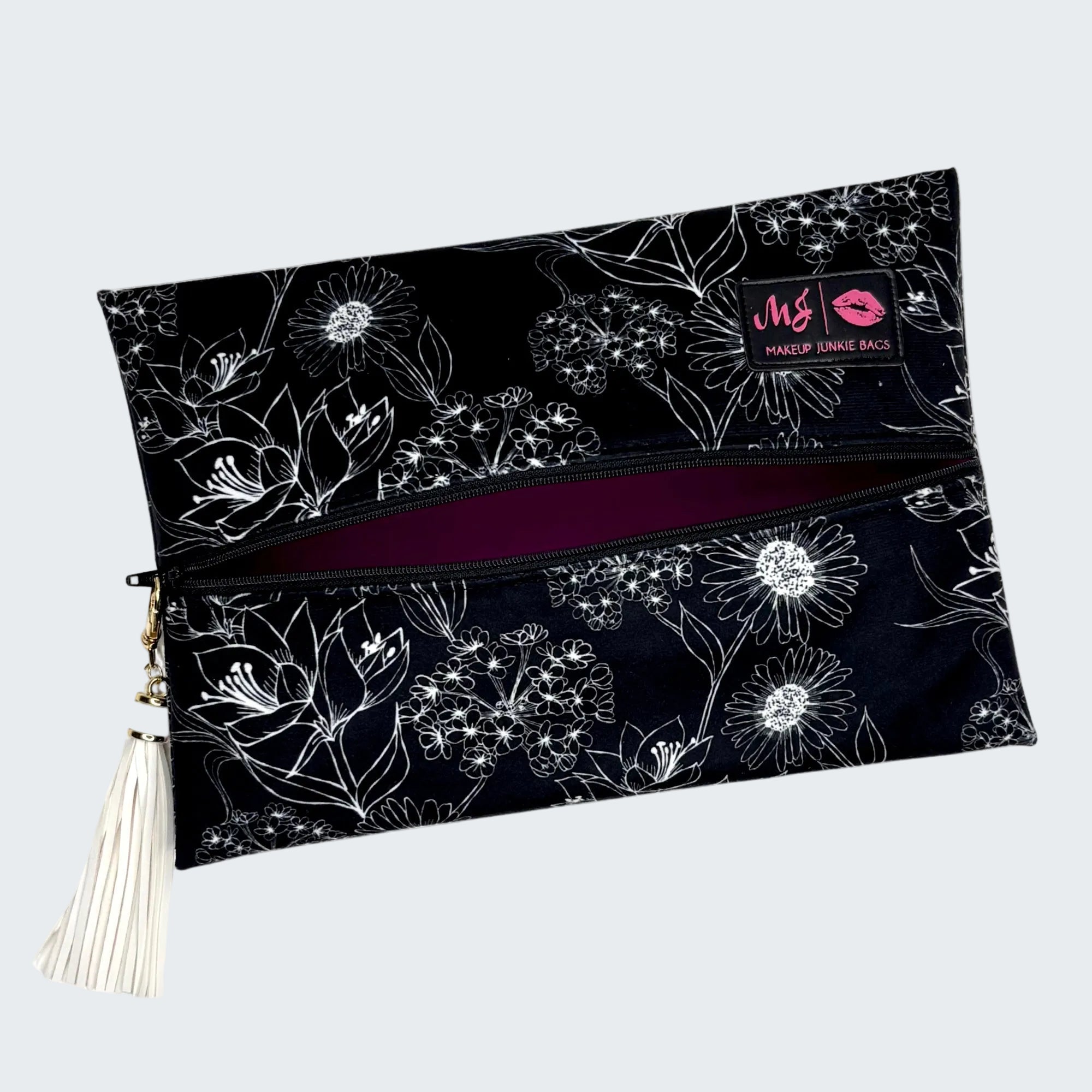 Floral-patterned makeup bag with a visible brand logo on a white background