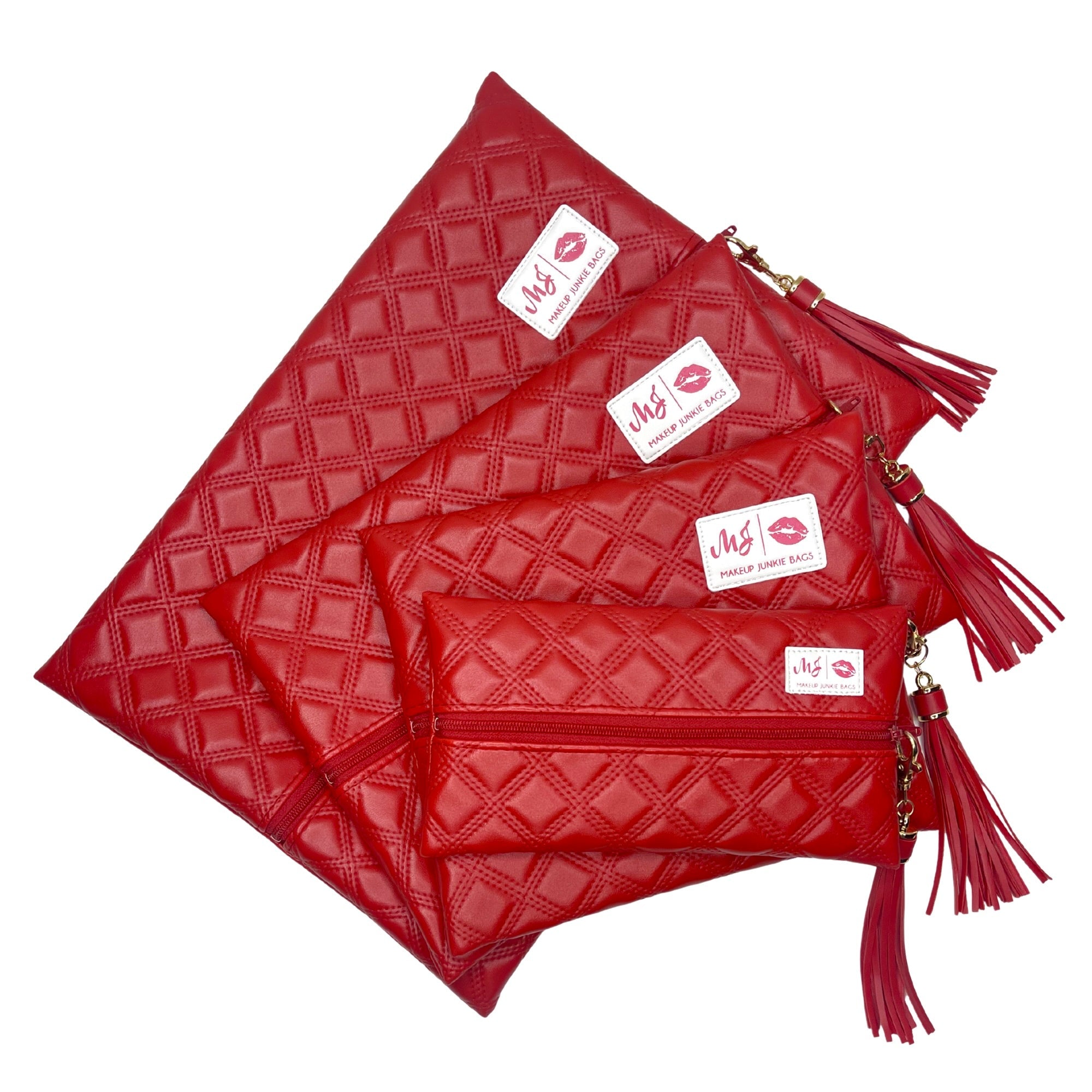 Set of red quilted handbags with tassels on a white background
