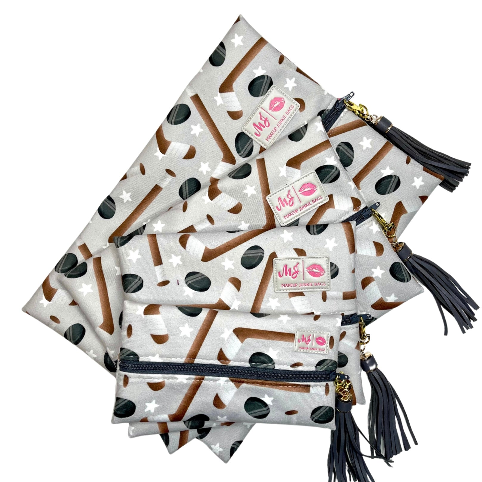 Set of pouches with polka dot pattern and tassels on a white background