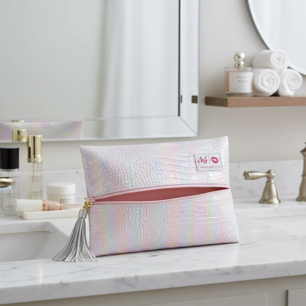 Iridescent makeup bag with a tassel on a light gray background