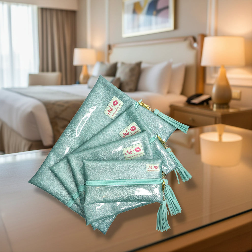 Set of glittery teal pouches with tassels and visible brand logo on a white background