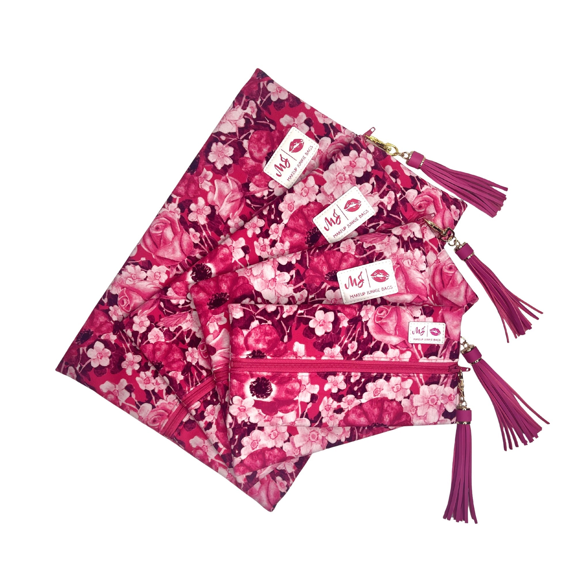 Set of pink floral pouches with tassels on a white background