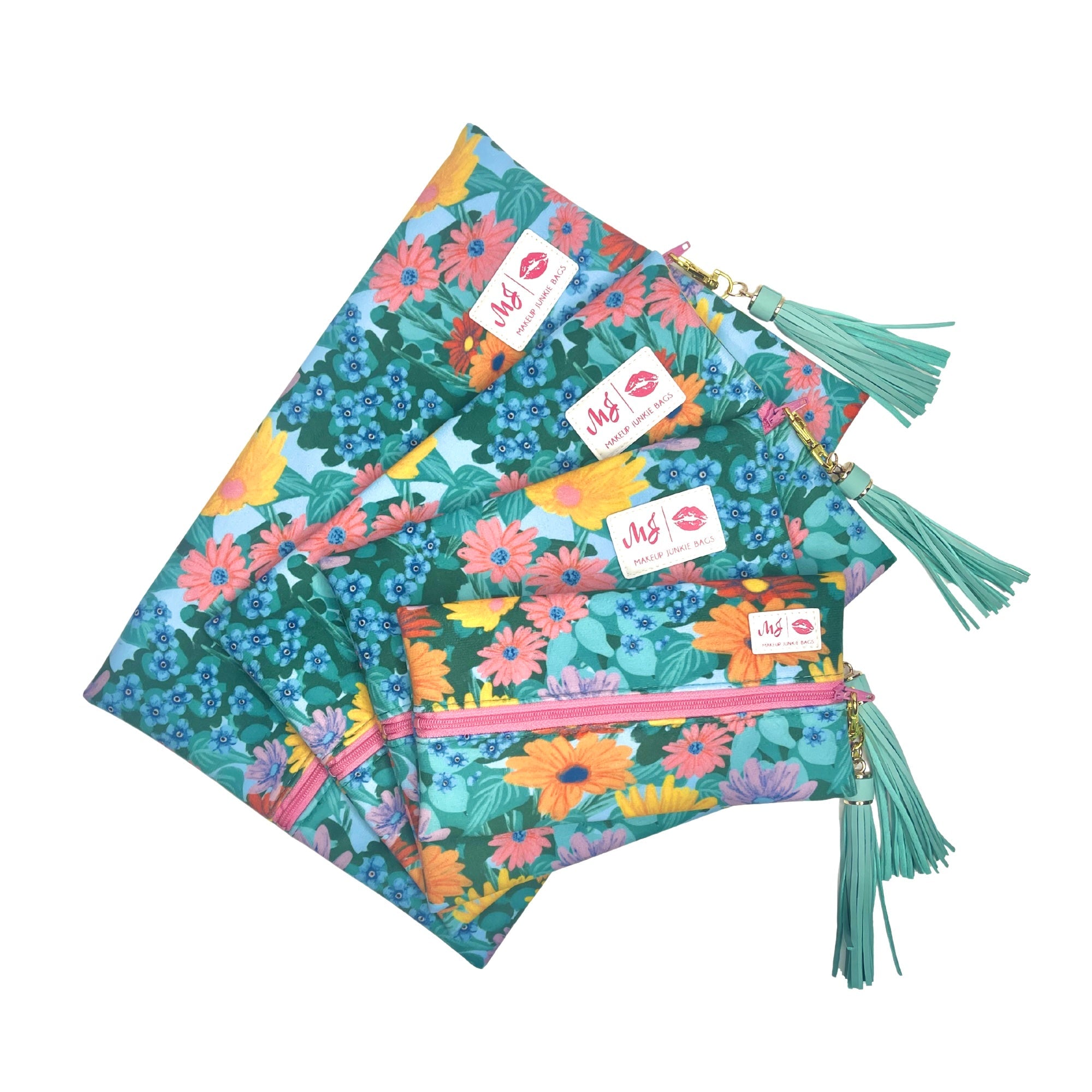 Floral-patterned bags with tassels and visible brand labels on a white background