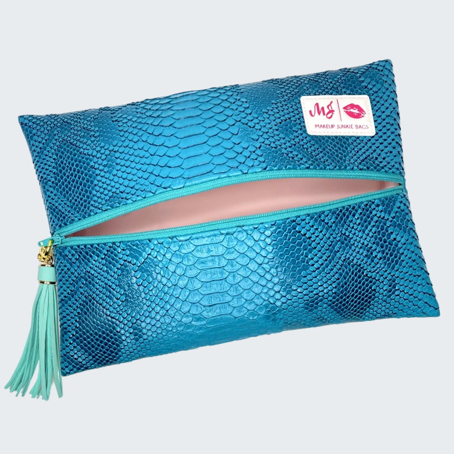 Blue mesh makeup bag with a tassel on a white background