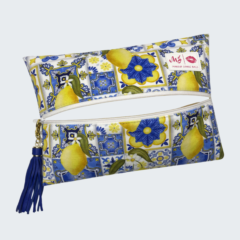 Patterned pouch with lemons and flowers on a white background