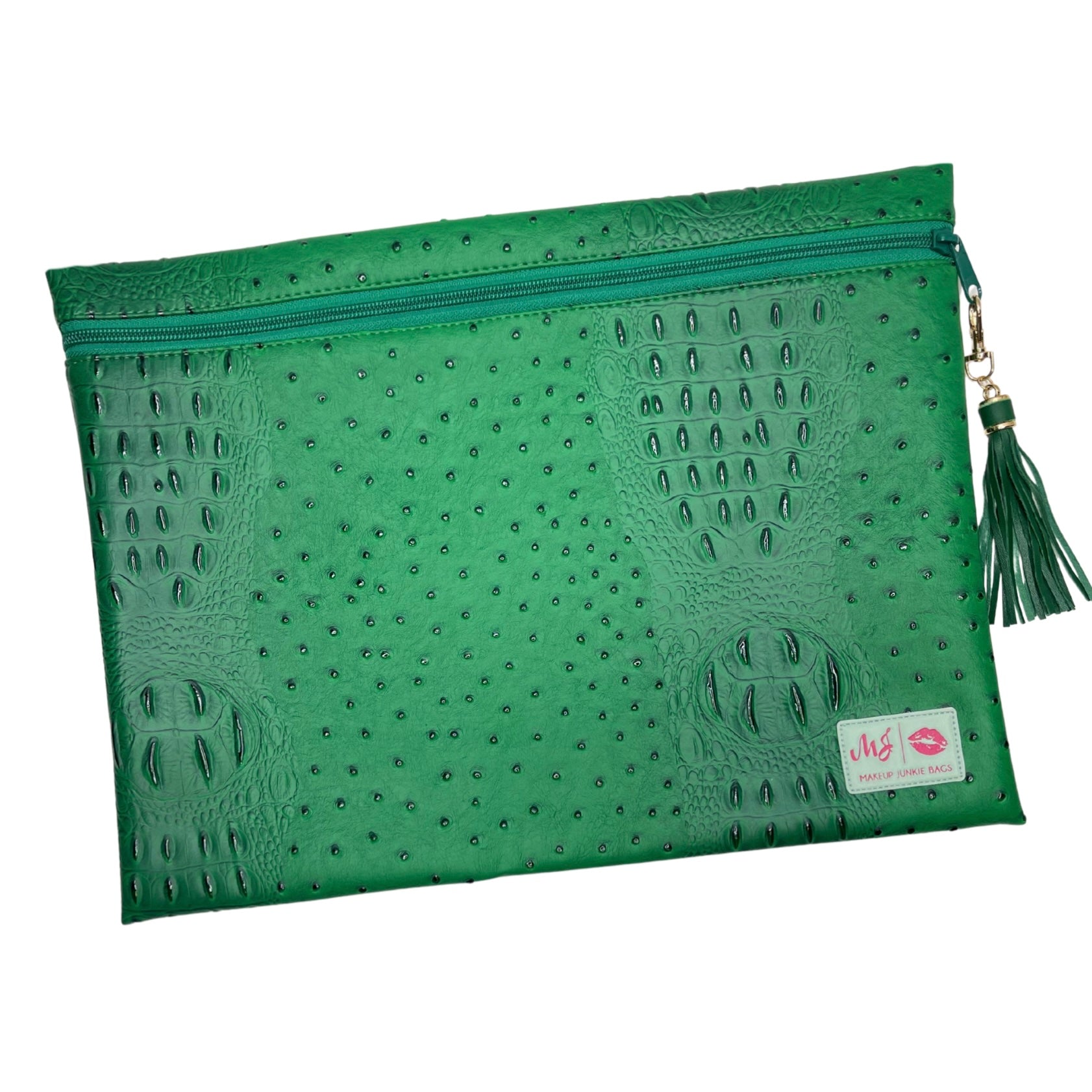 Green clutch bag with textured surface and tassel on a white background