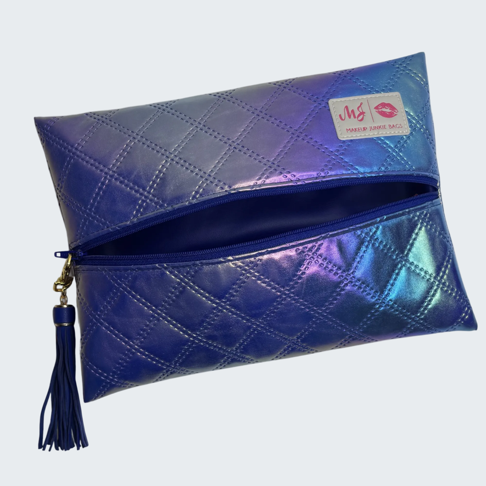 Iridescent clutch bag with a tassel on a white background