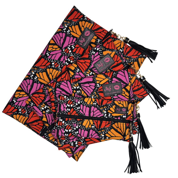 Colorful butterfly-patterned bags with tassels on a white background