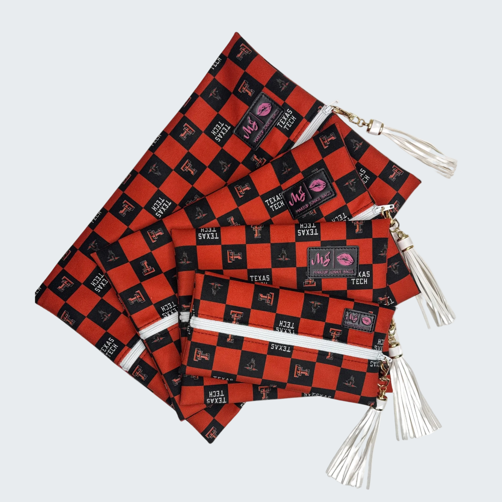 Set of red and black checkered bags with tassels on a white background