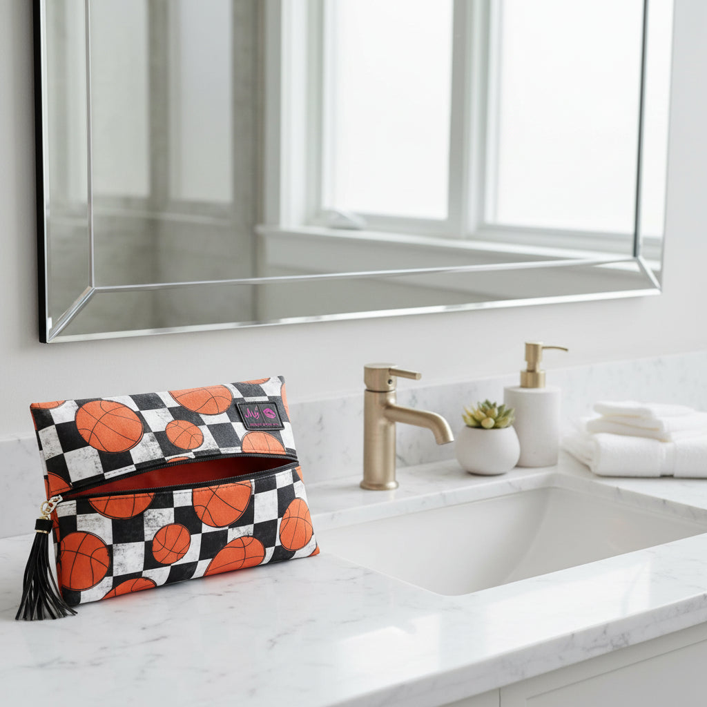 Makeup bag with basketball pattern on a light gray background