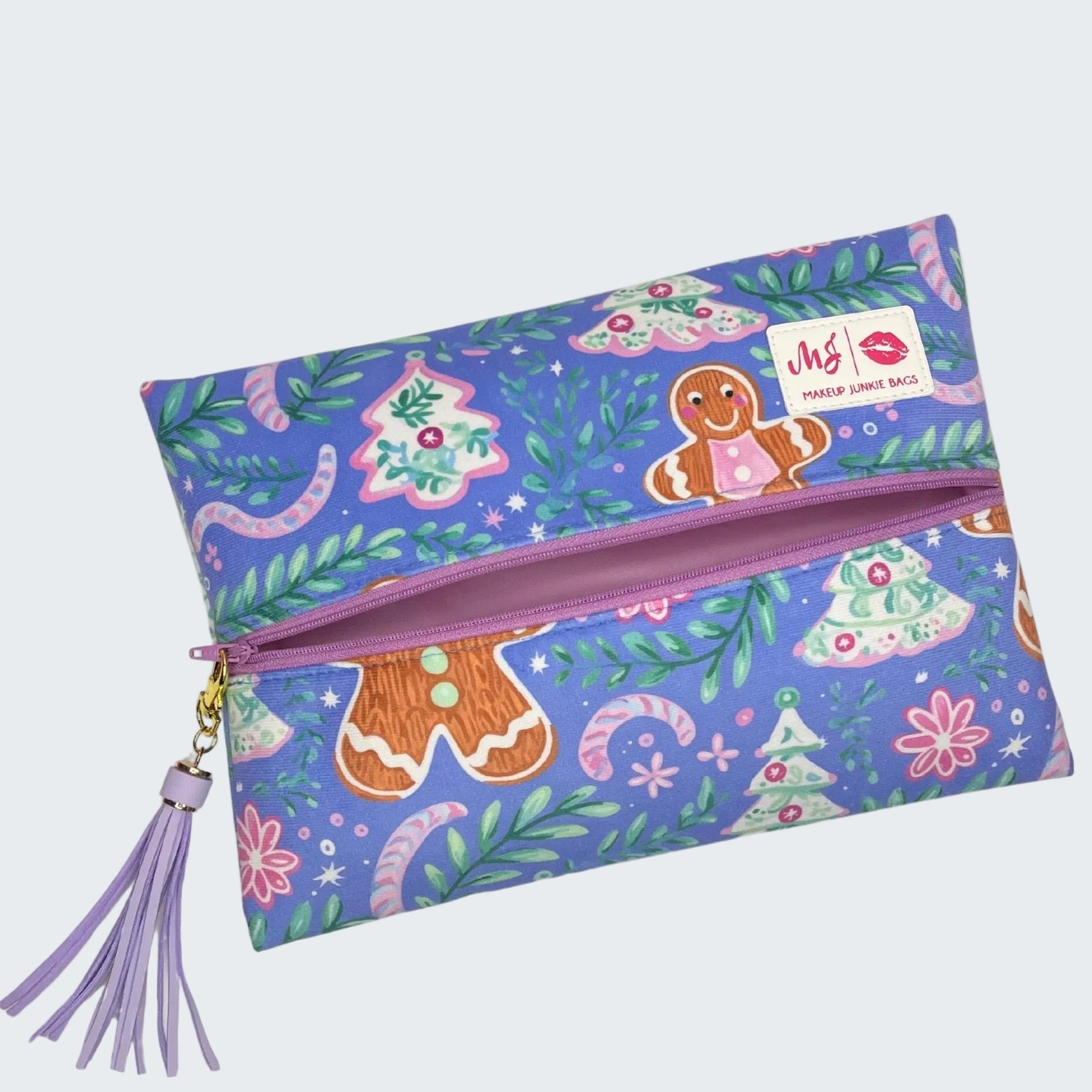 Colorful pouch with gingerbread design and tassel on a white background