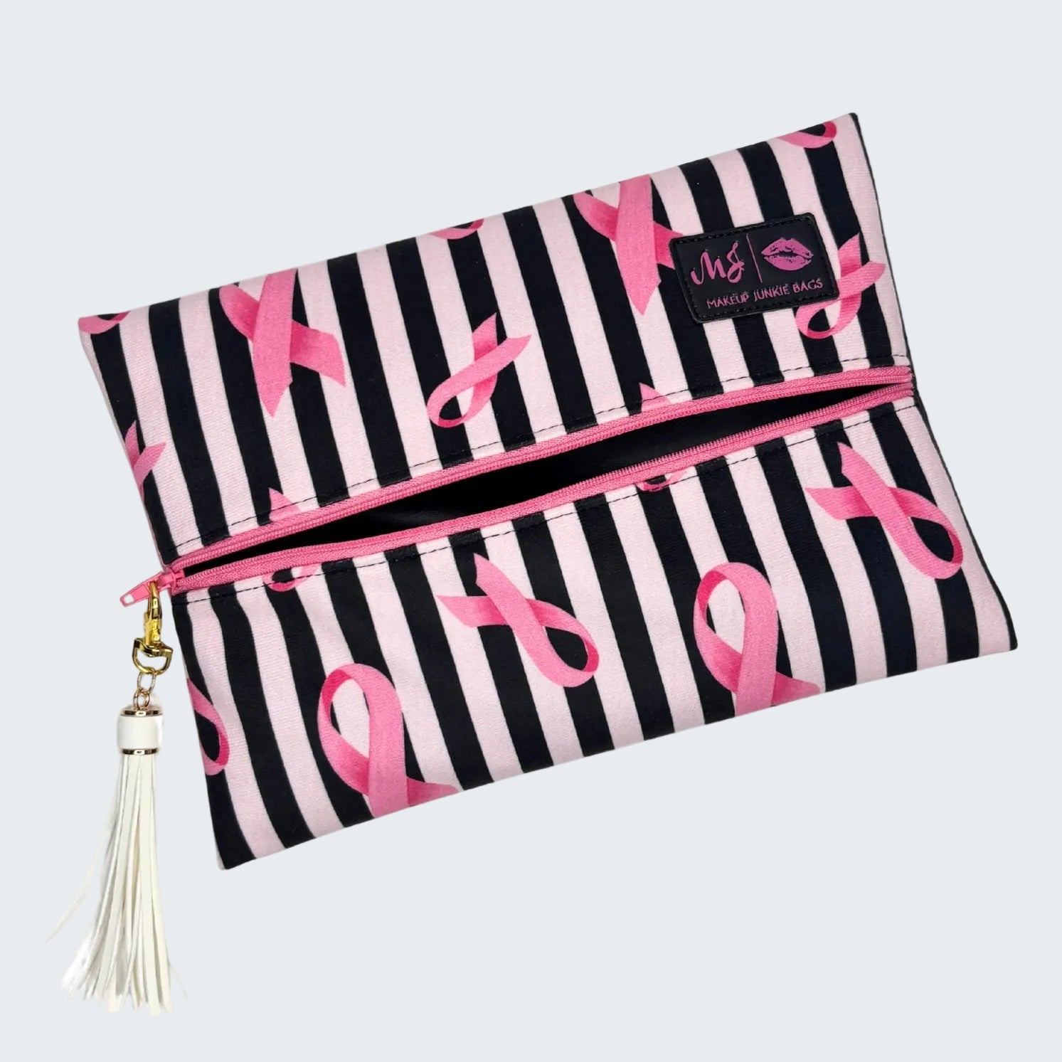 Makeup bag with pink ribbon design and tassel on a white background