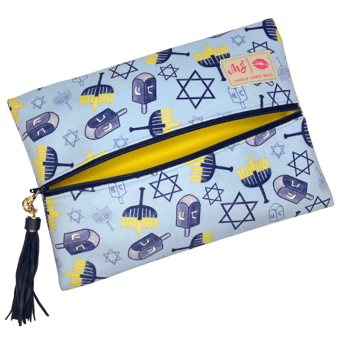 Pouch with Hanukkah-themed design featuring dreidels and stars of David on a light blue background.